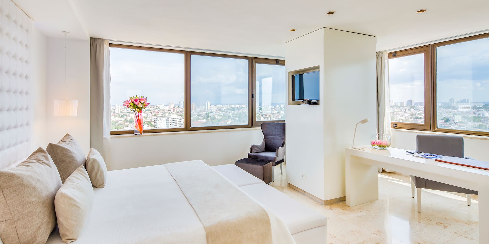 a bedroom with a large bed and a television