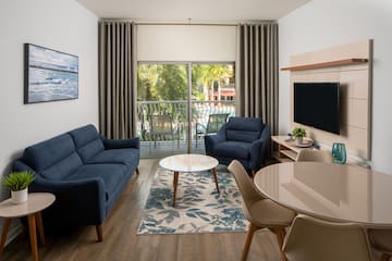 a living room with a table and chairs