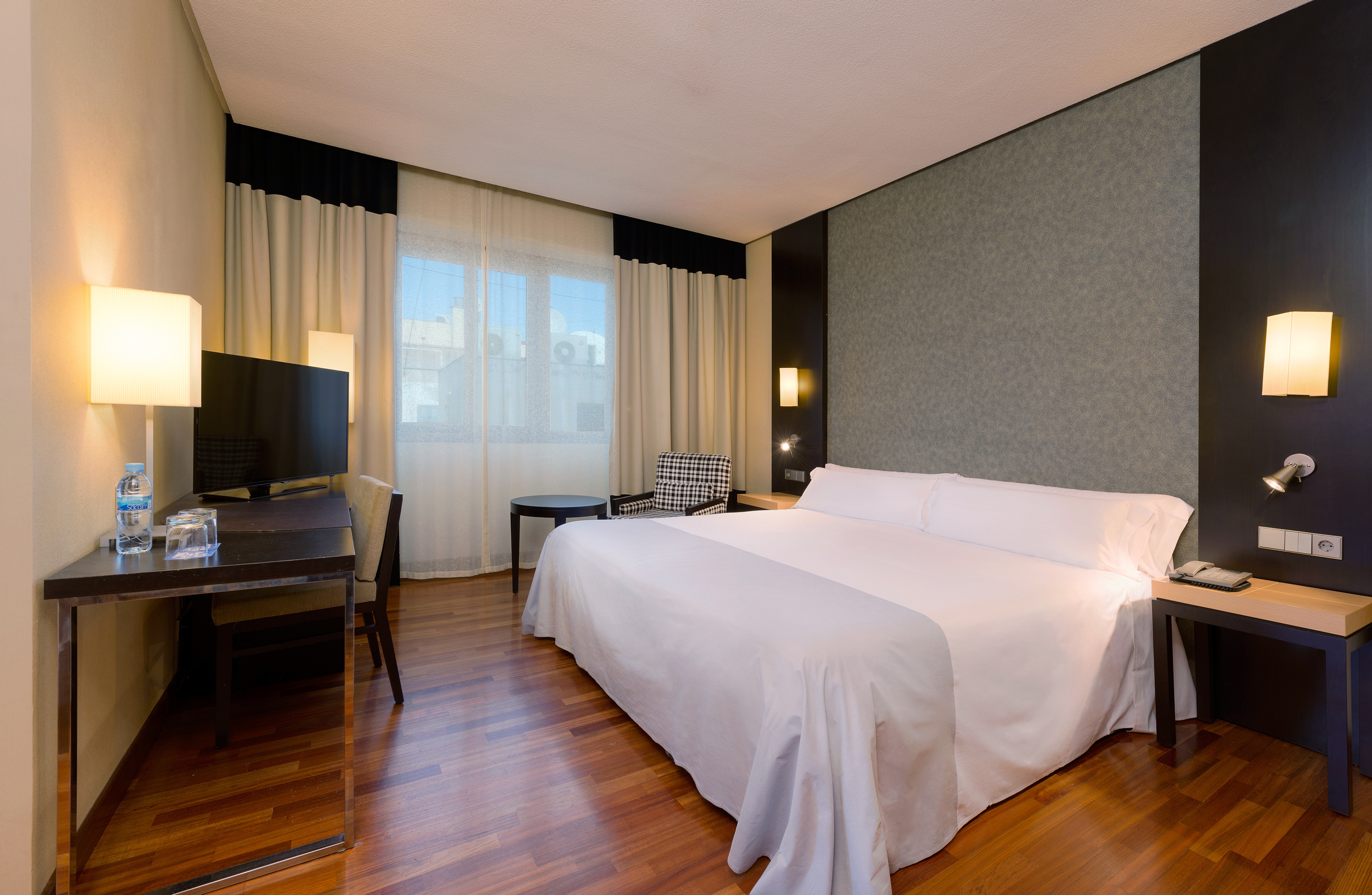 a room with a bed and a television