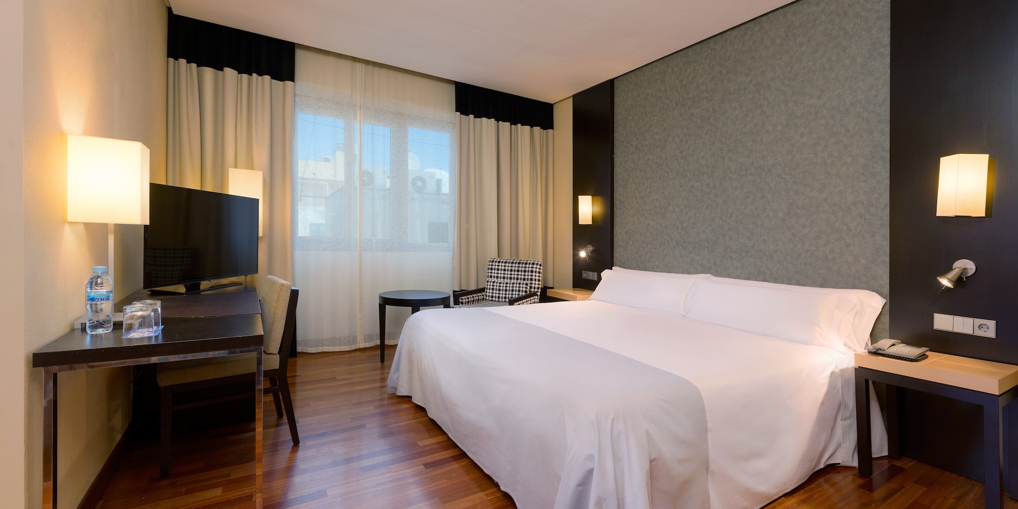 a room with a bed and a television