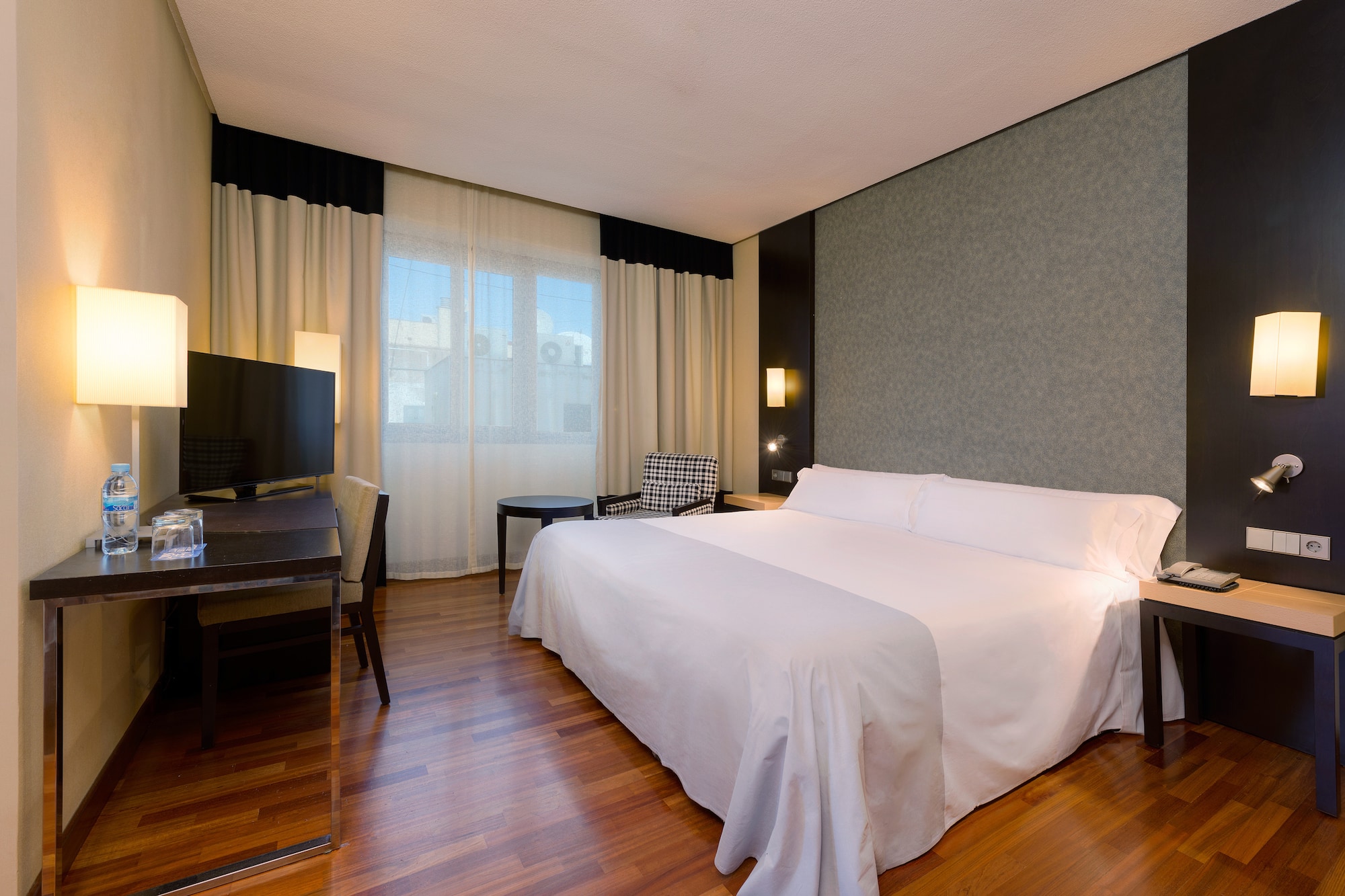 a room with a bed and a television