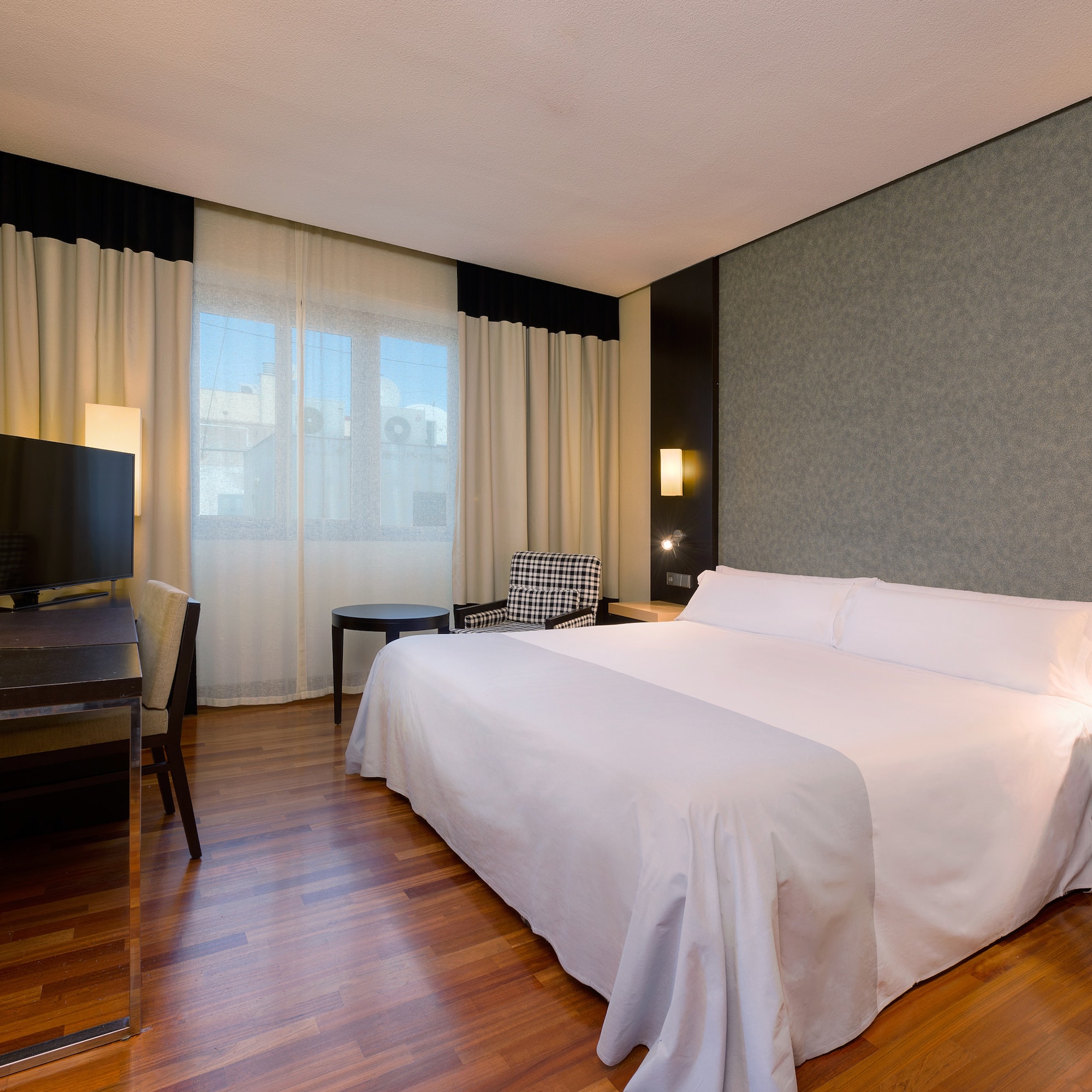 a room with a bed and a television