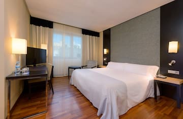 a room with a bed and a television