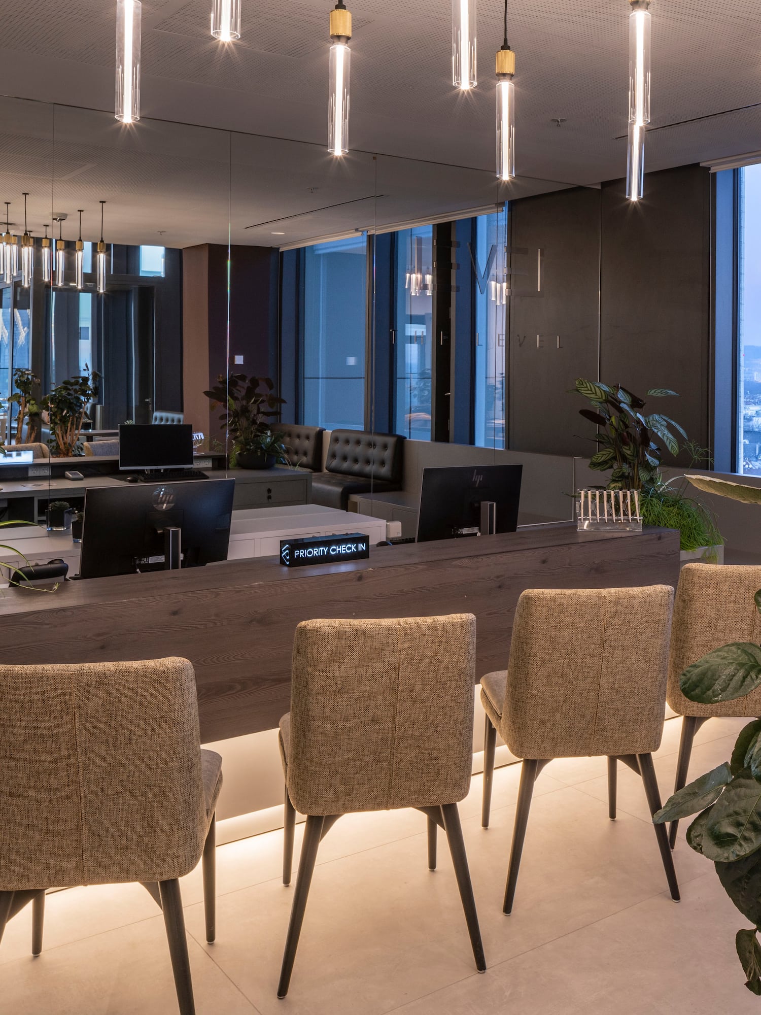 a room with chairs and a table and plants