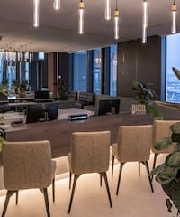 a room with chairs and a table and plants