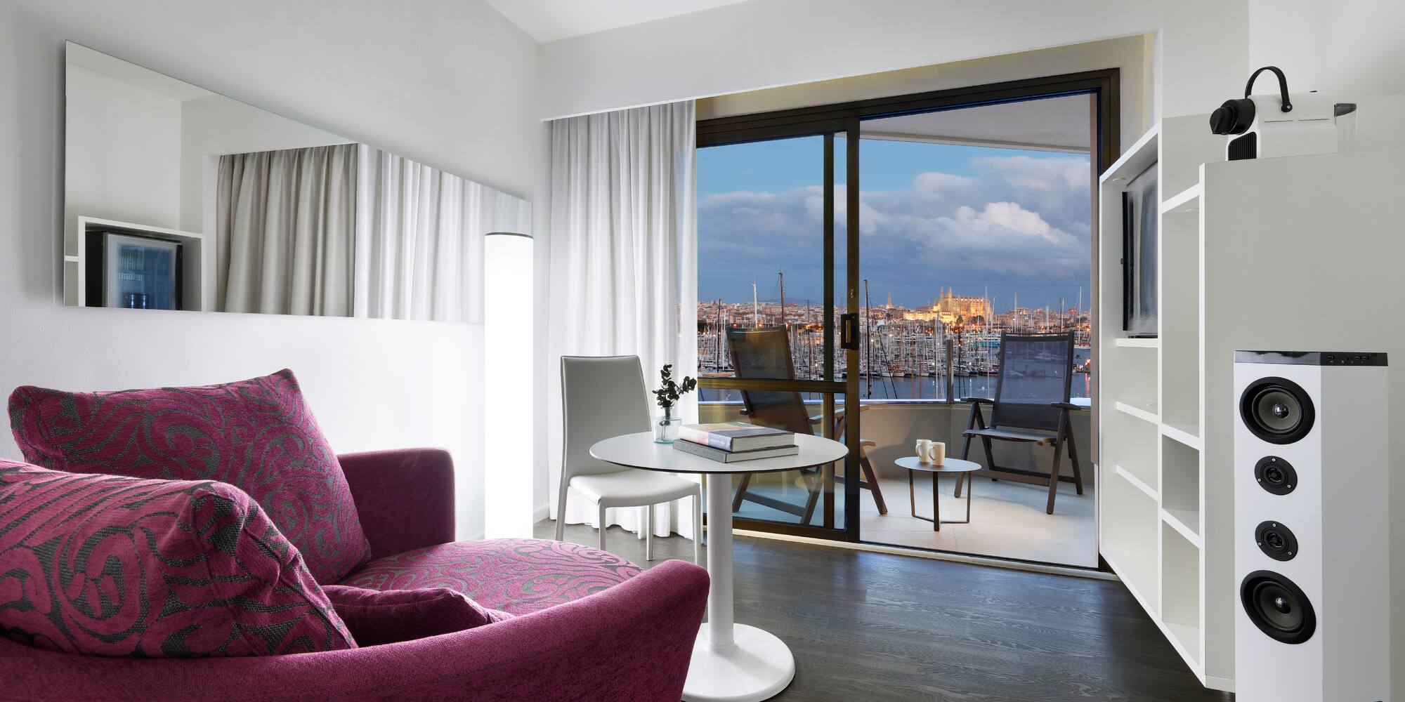 a room with a purple couch and a table and a television