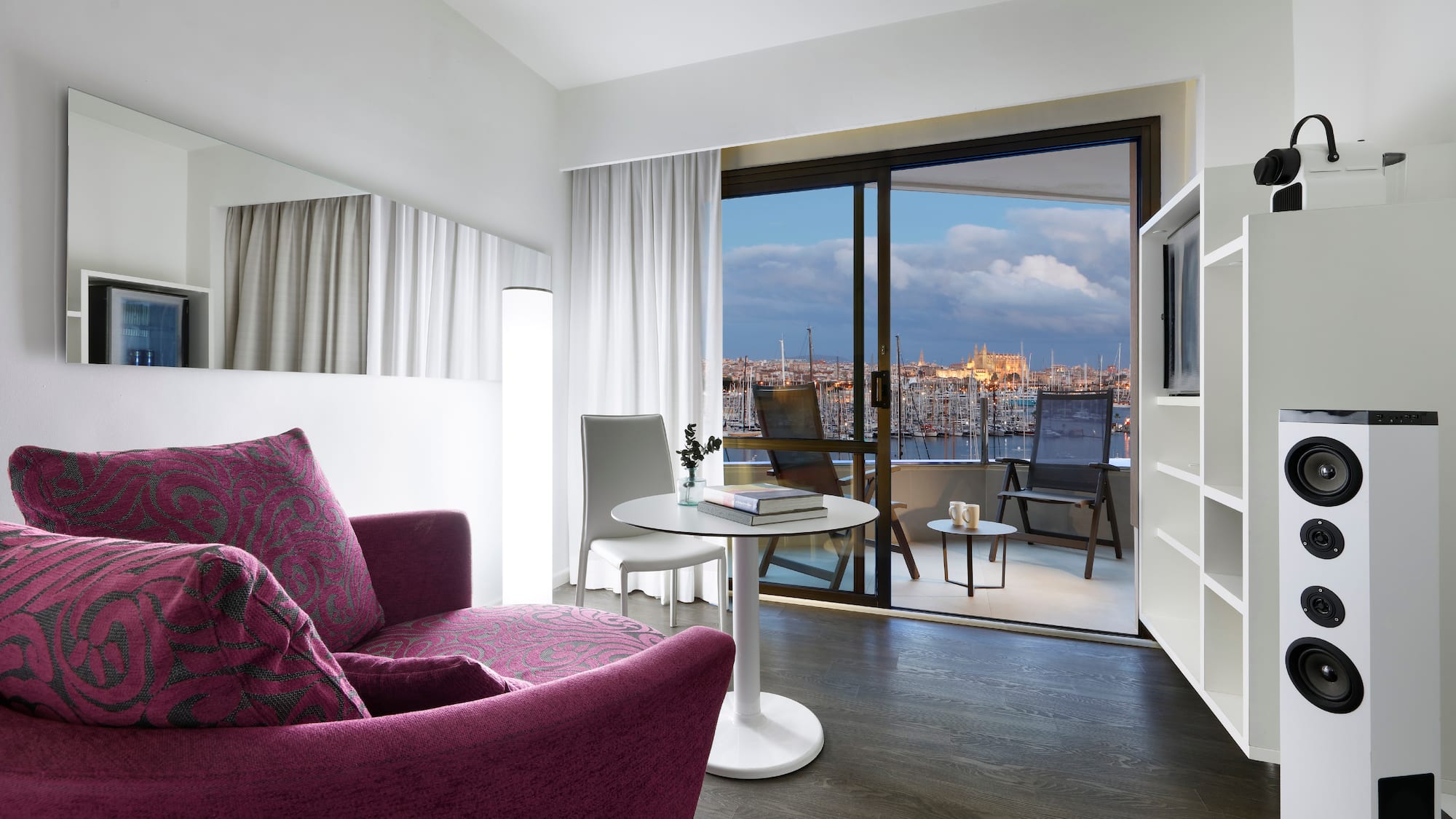 a room with a purple couch and a table and a television