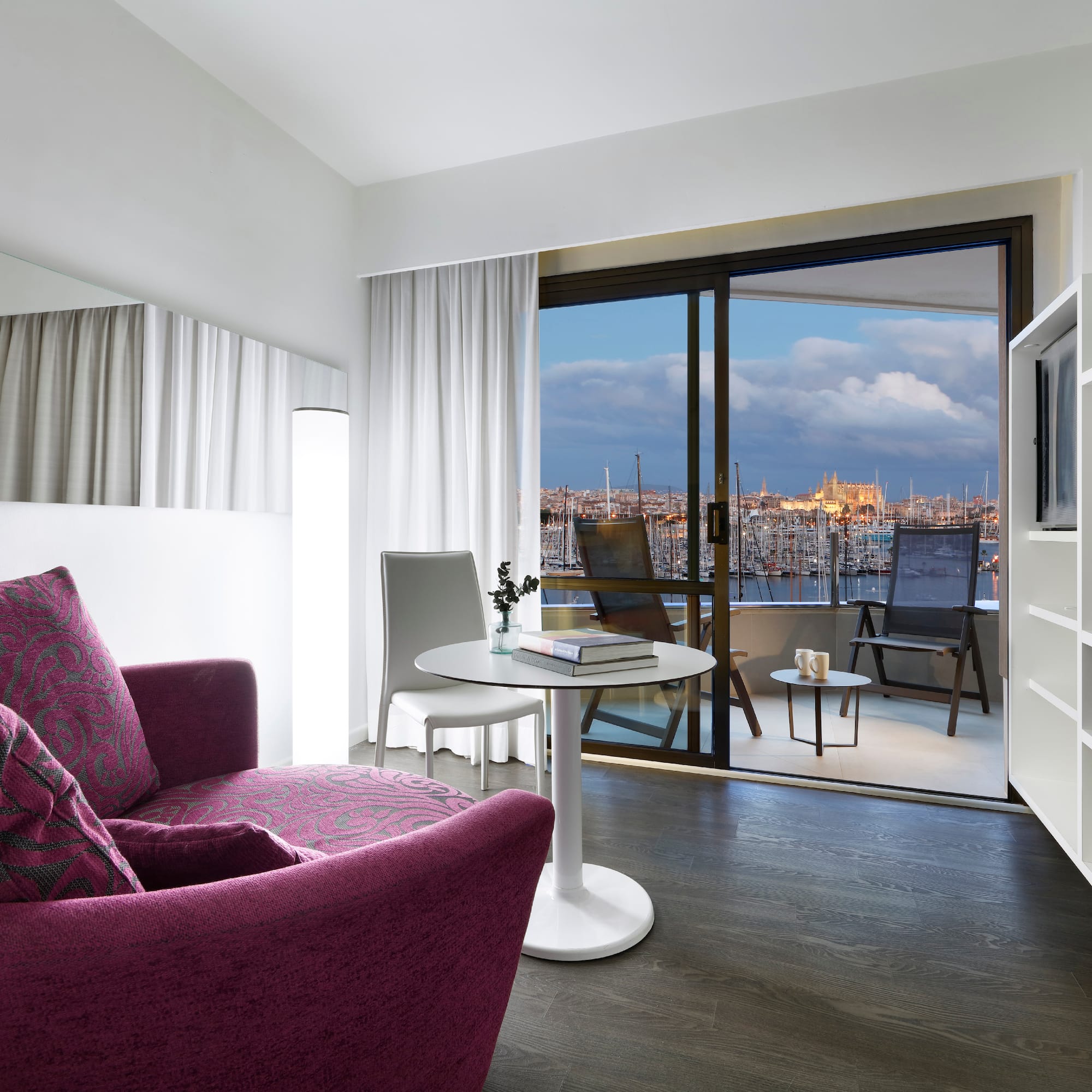 a room with a purple couch and a table and a television