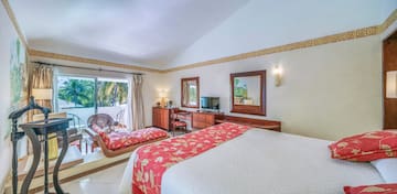 a room with a bed and a television