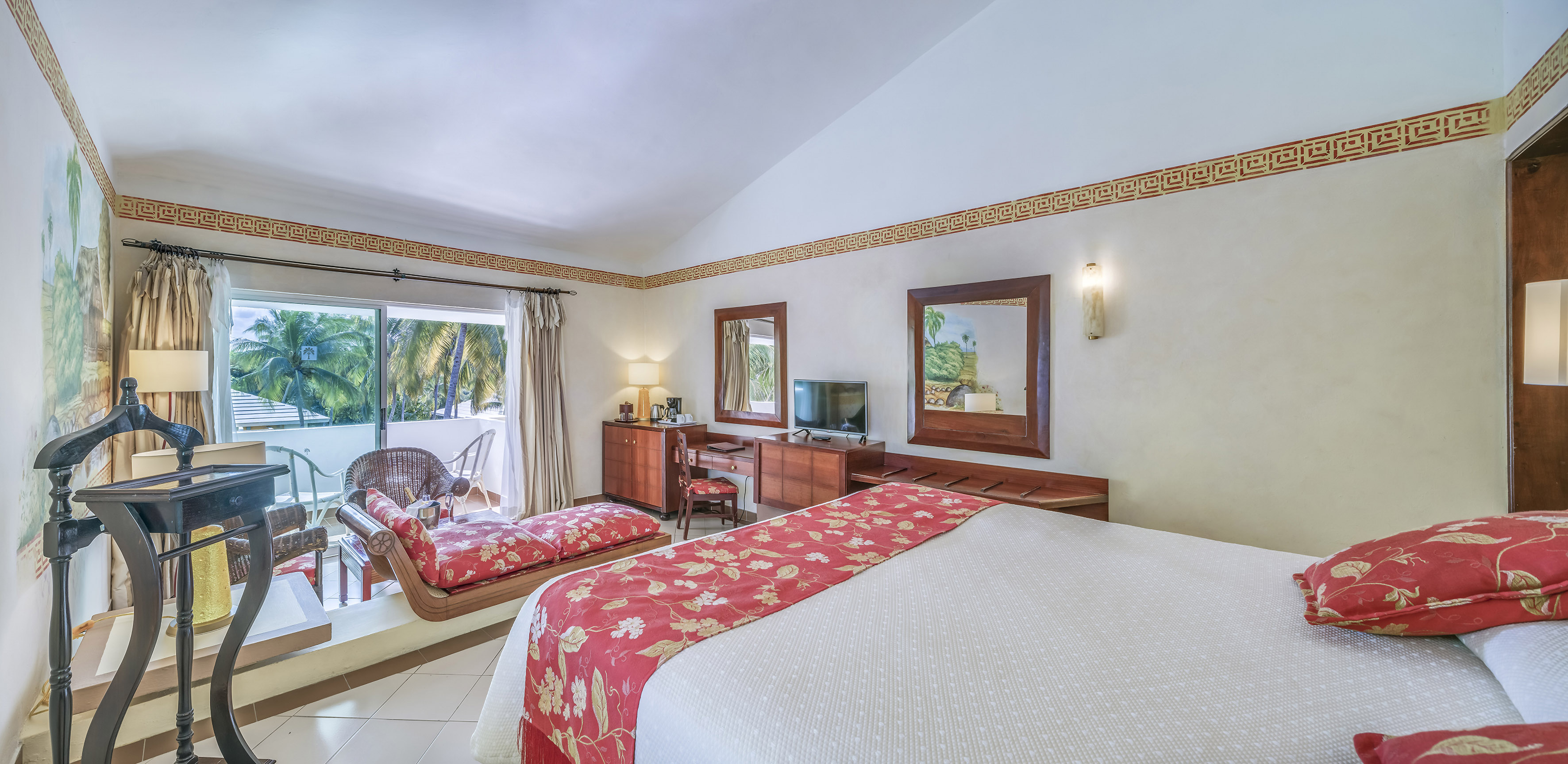 a room with a bed and a television