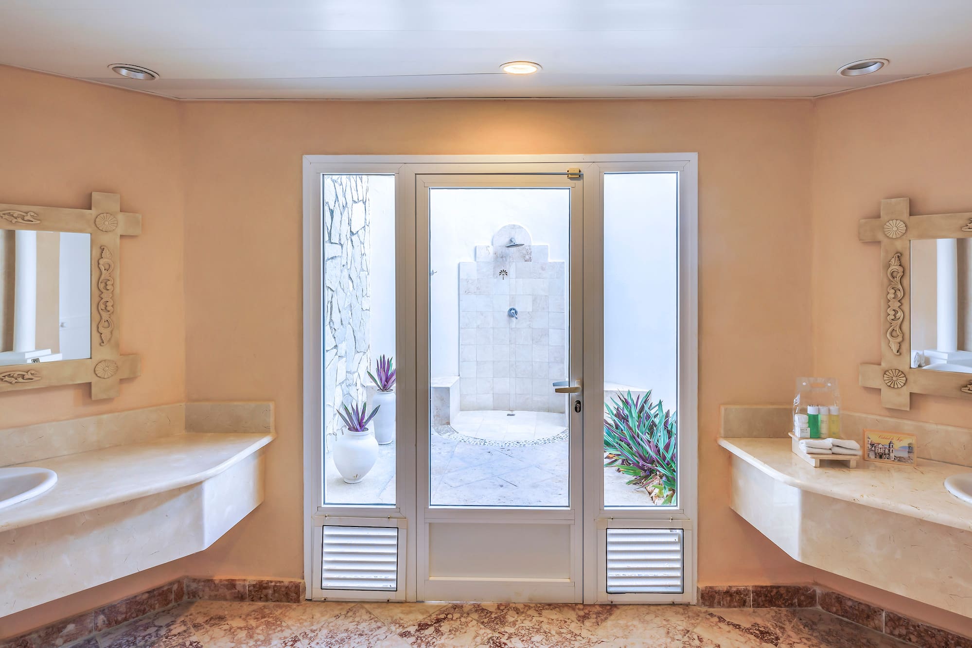 a bathroom with marble countertops and sinks