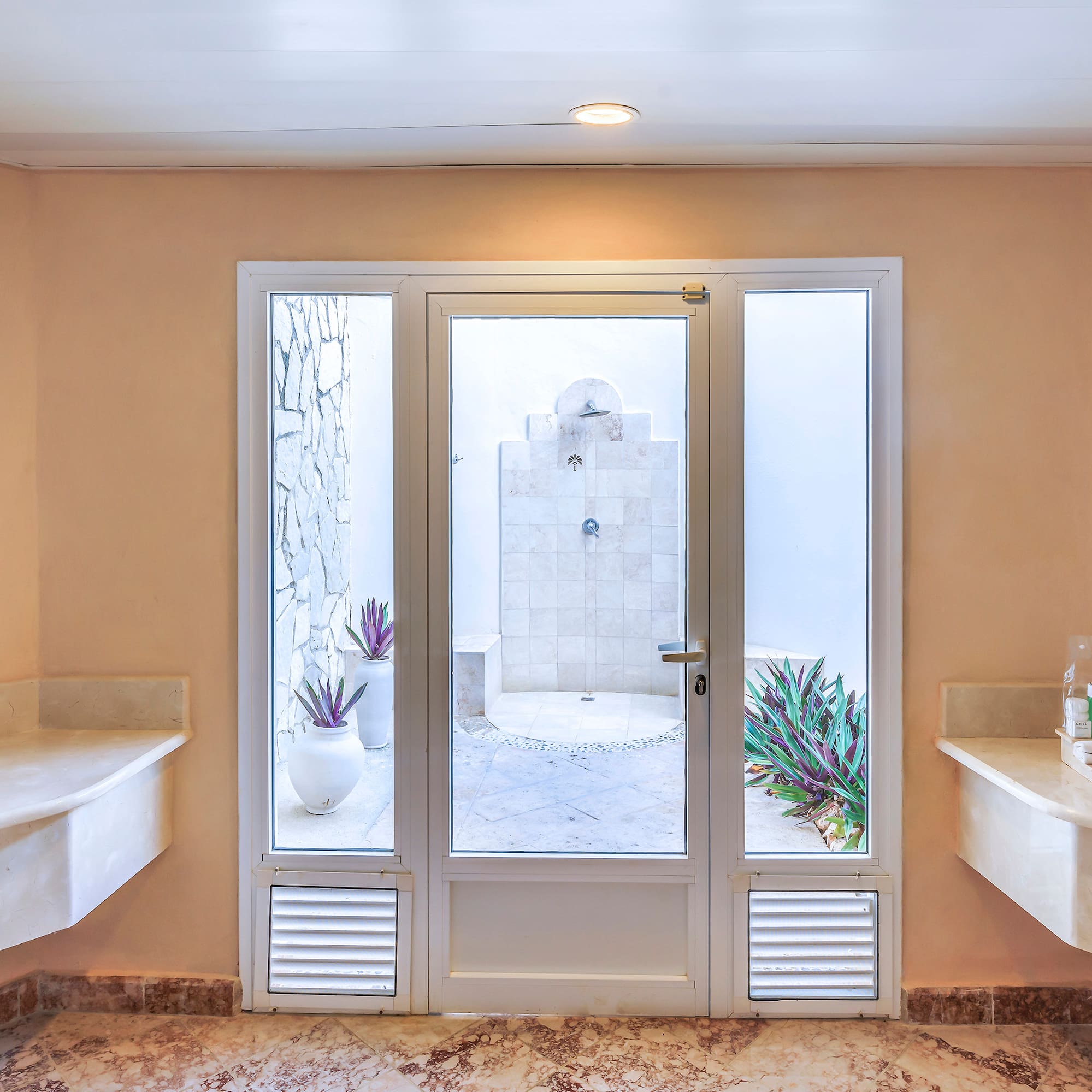 a bathroom with marble countertops and sinks
