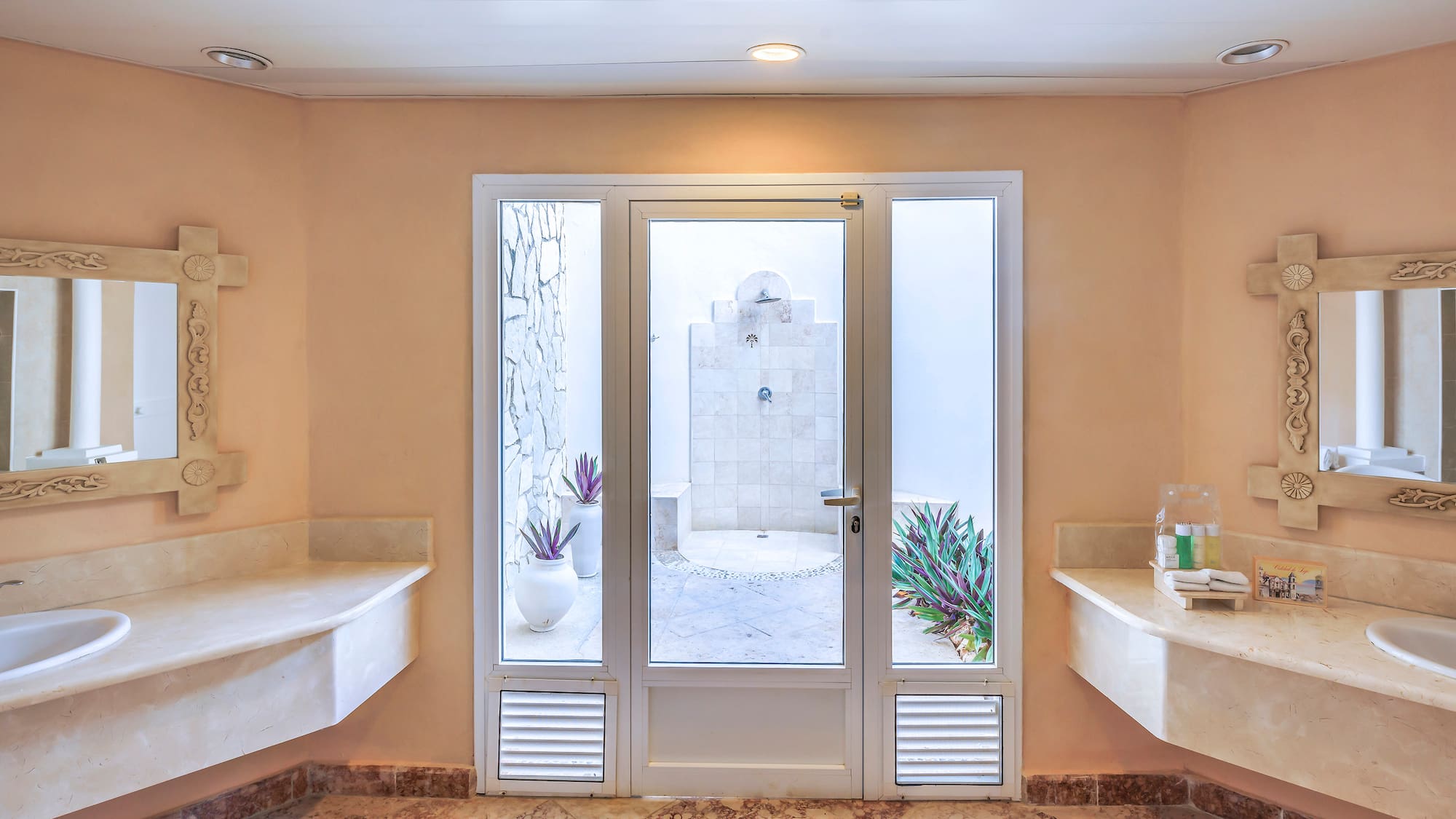a bathroom with marble countertops and sinks