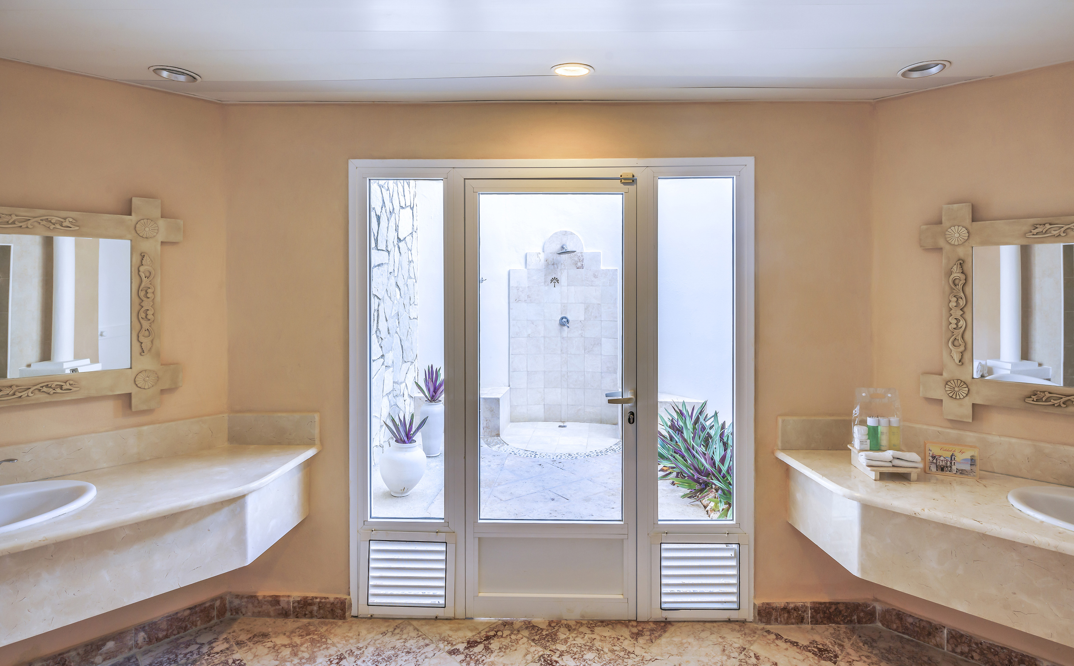 a bathroom with marble countertops and sinks