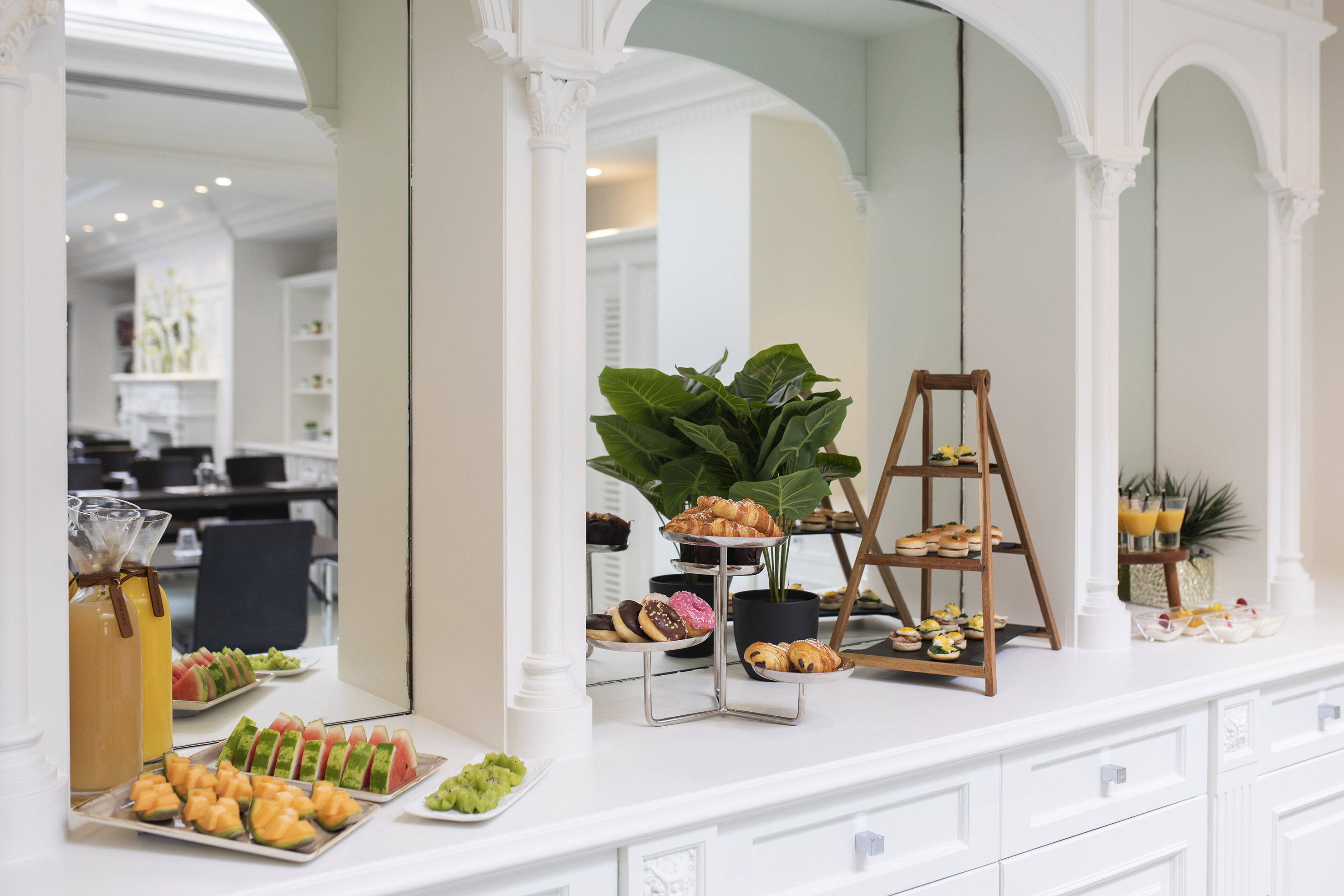 Elegant breakfast buffet with pastries, fresh fruit, and juices.