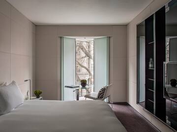 a bedroom with a bed and a chair