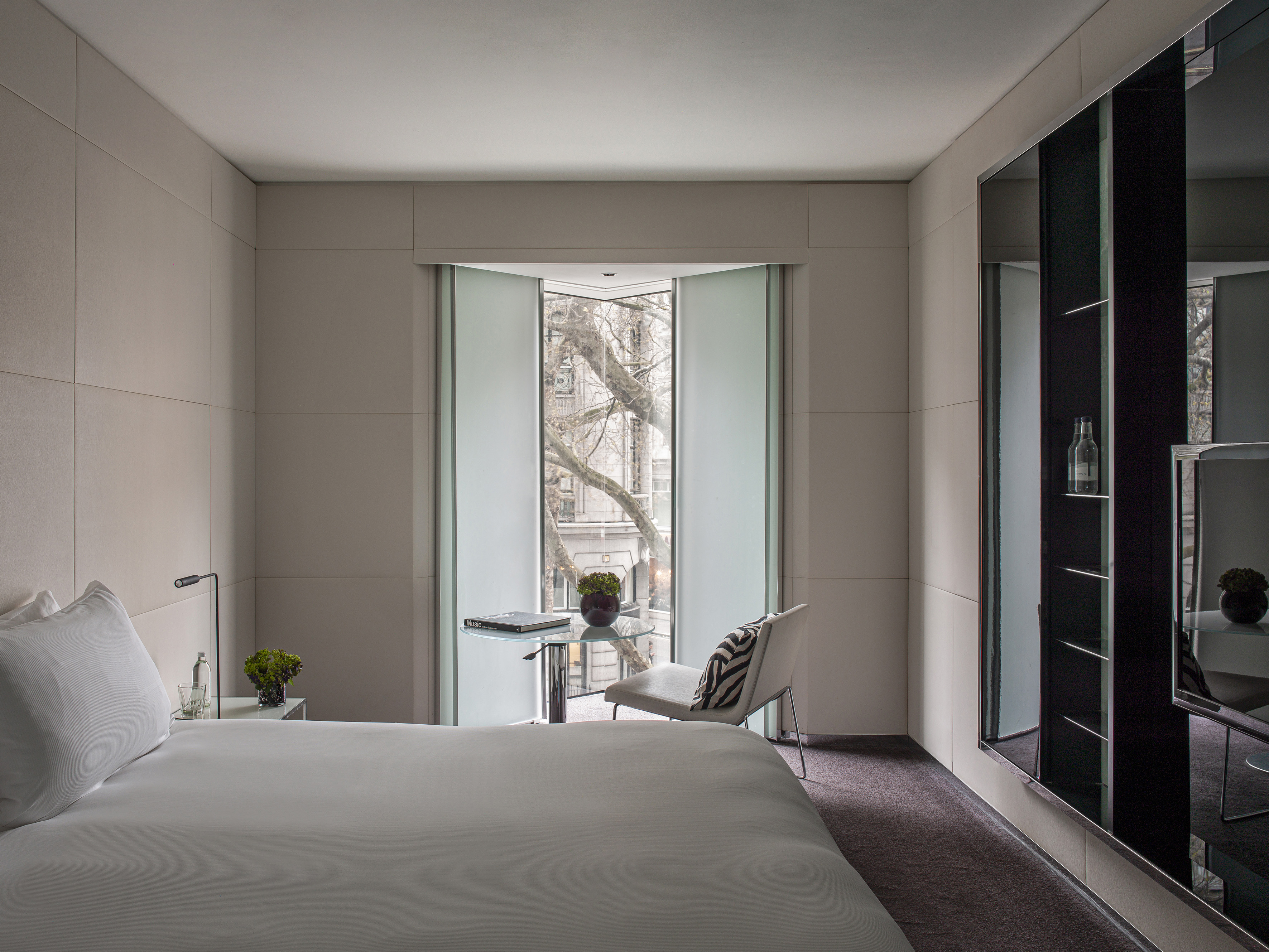 a bedroom with a bed and a chair
