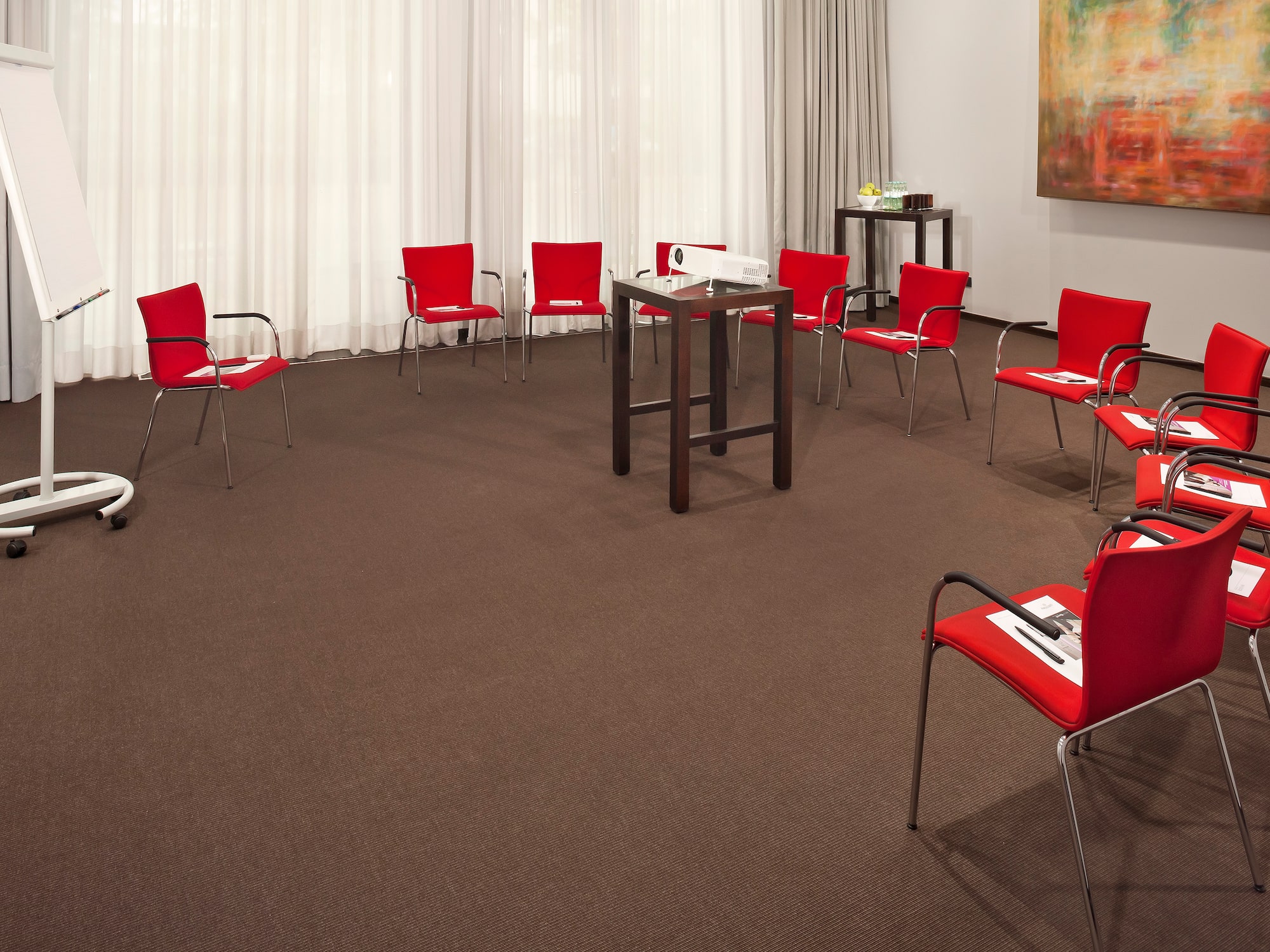a room with red chairs and a table