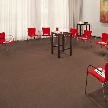 a room with red chairs and a table
