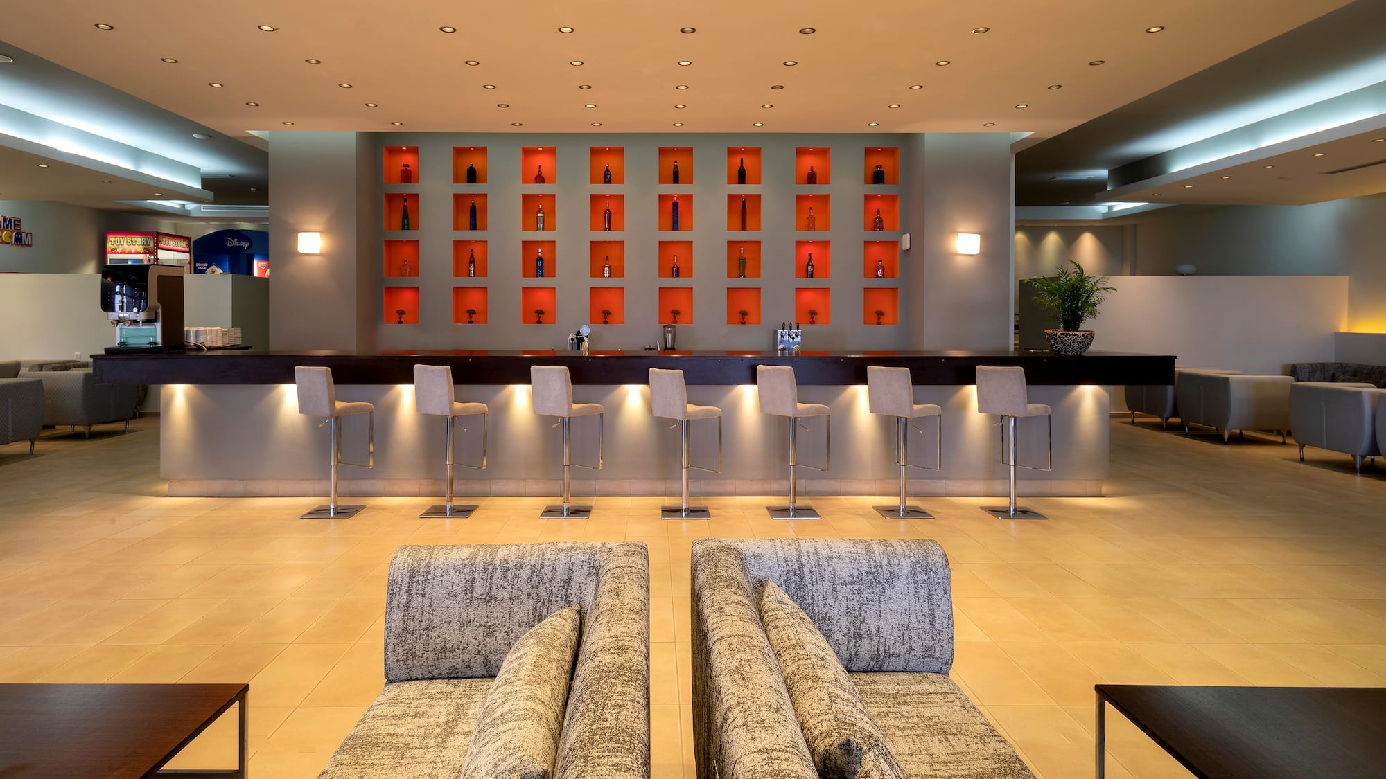 a room with a bar and chairs