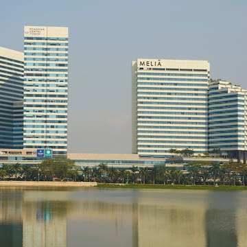 a group of tall buildings next to a body of water