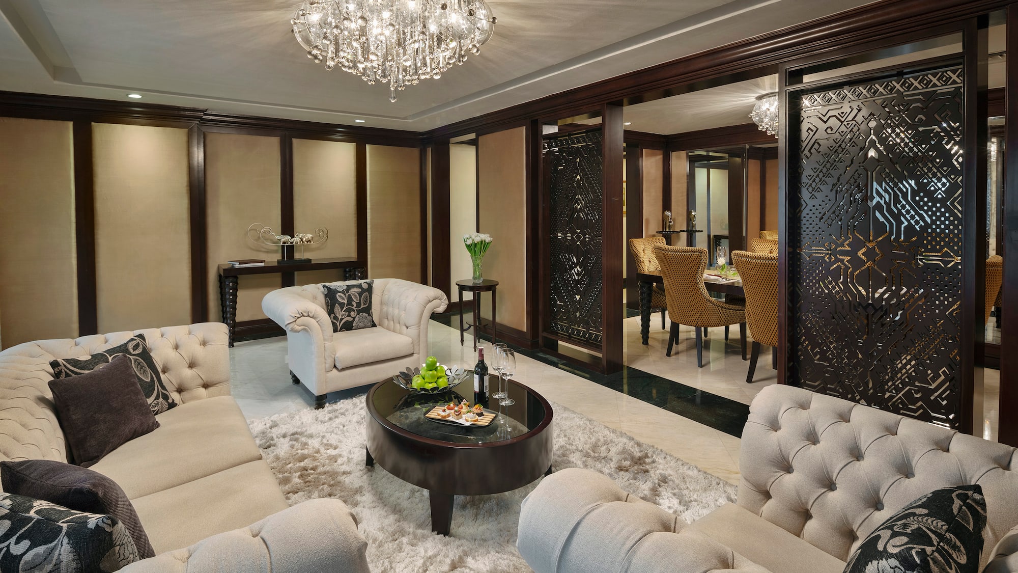 a room with a chandelier and couches
