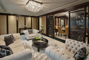 a room with a chandelier and couches