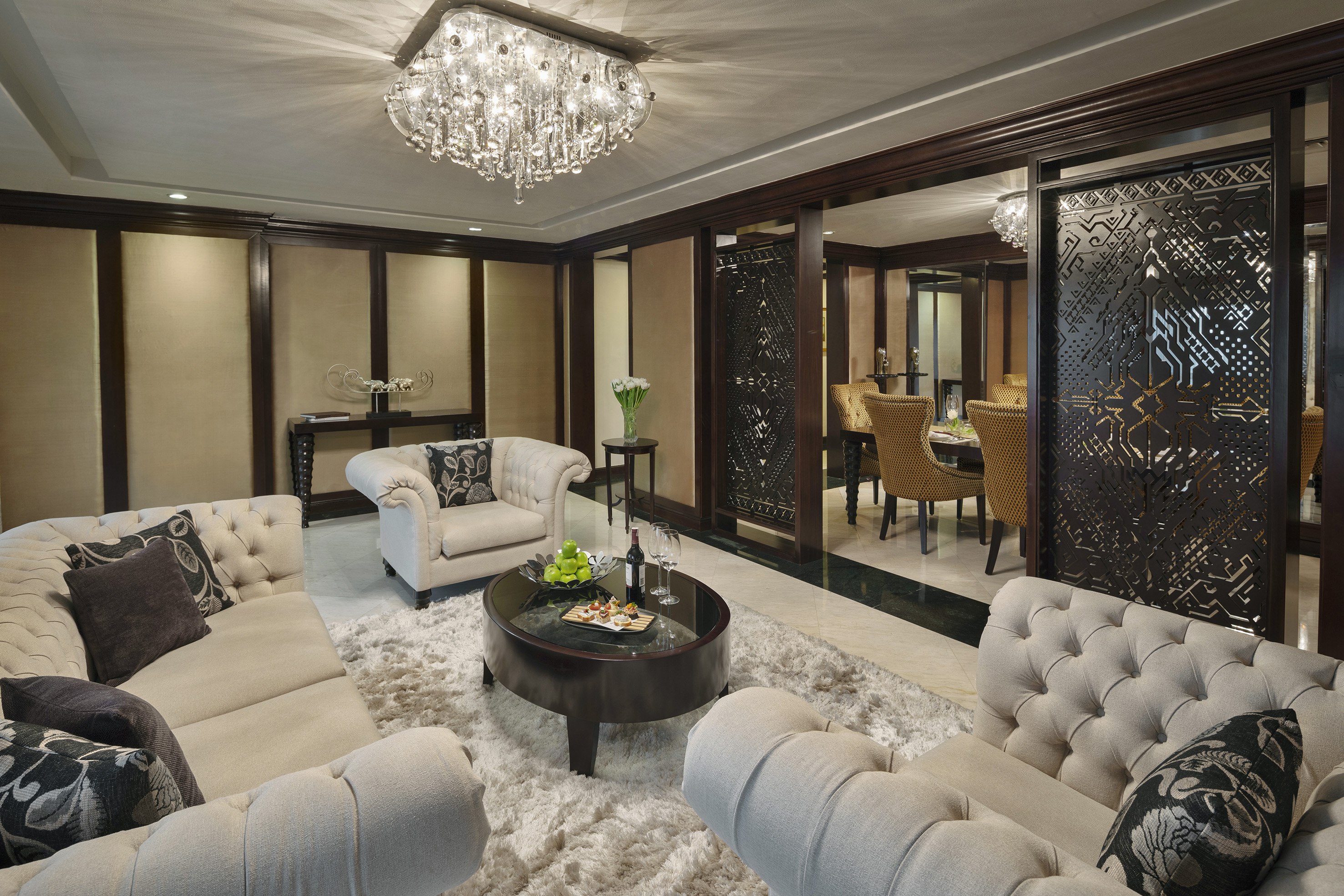 a room with a chandelier and couches