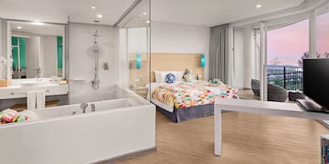 a room with a bathtub and a bed