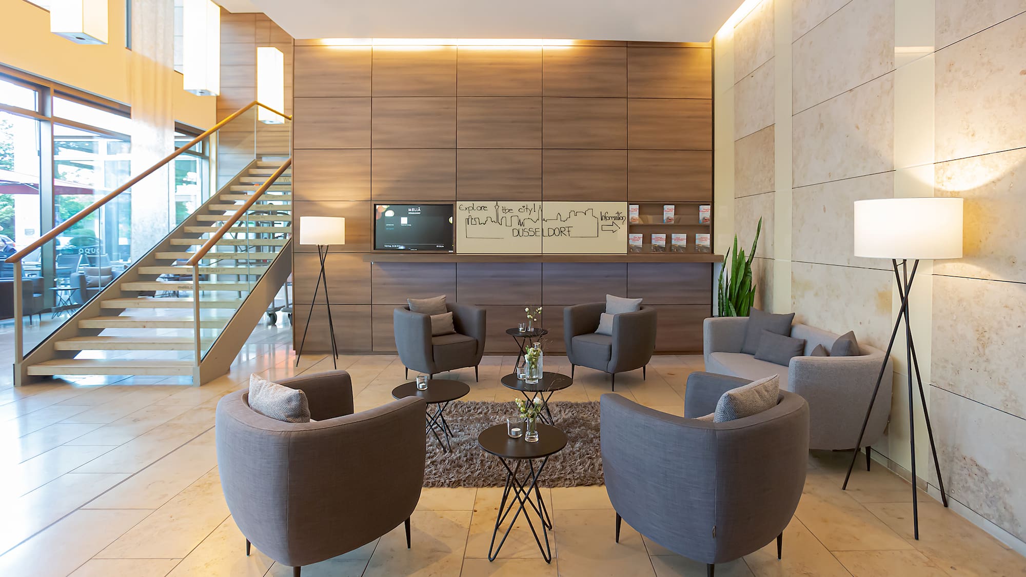 a room with a couch and chairs