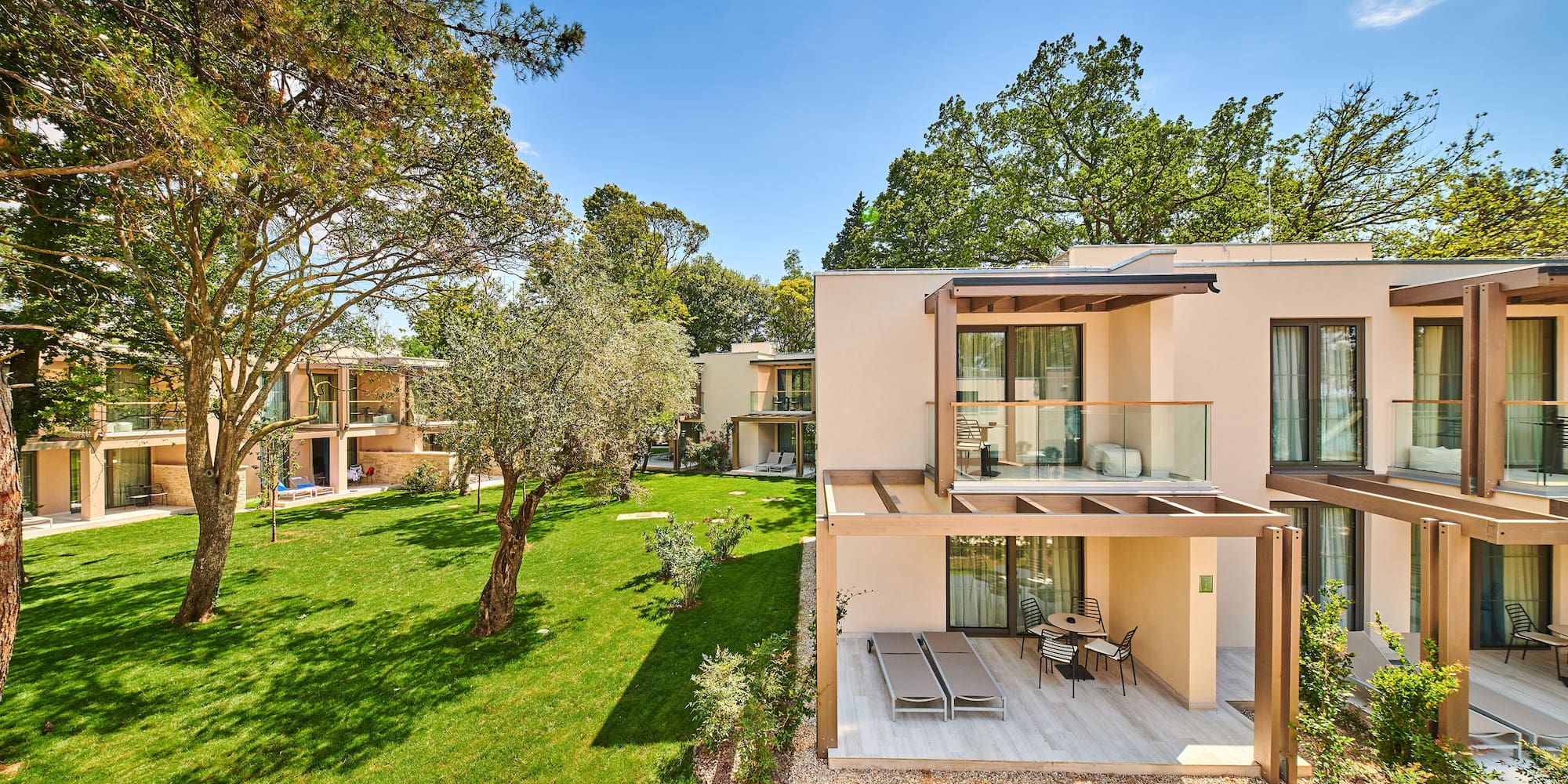 a building with a patio and grass in front of it