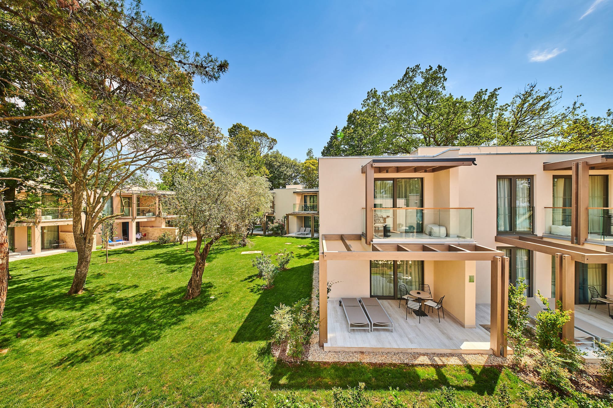 a building with a patio and grass in front of it