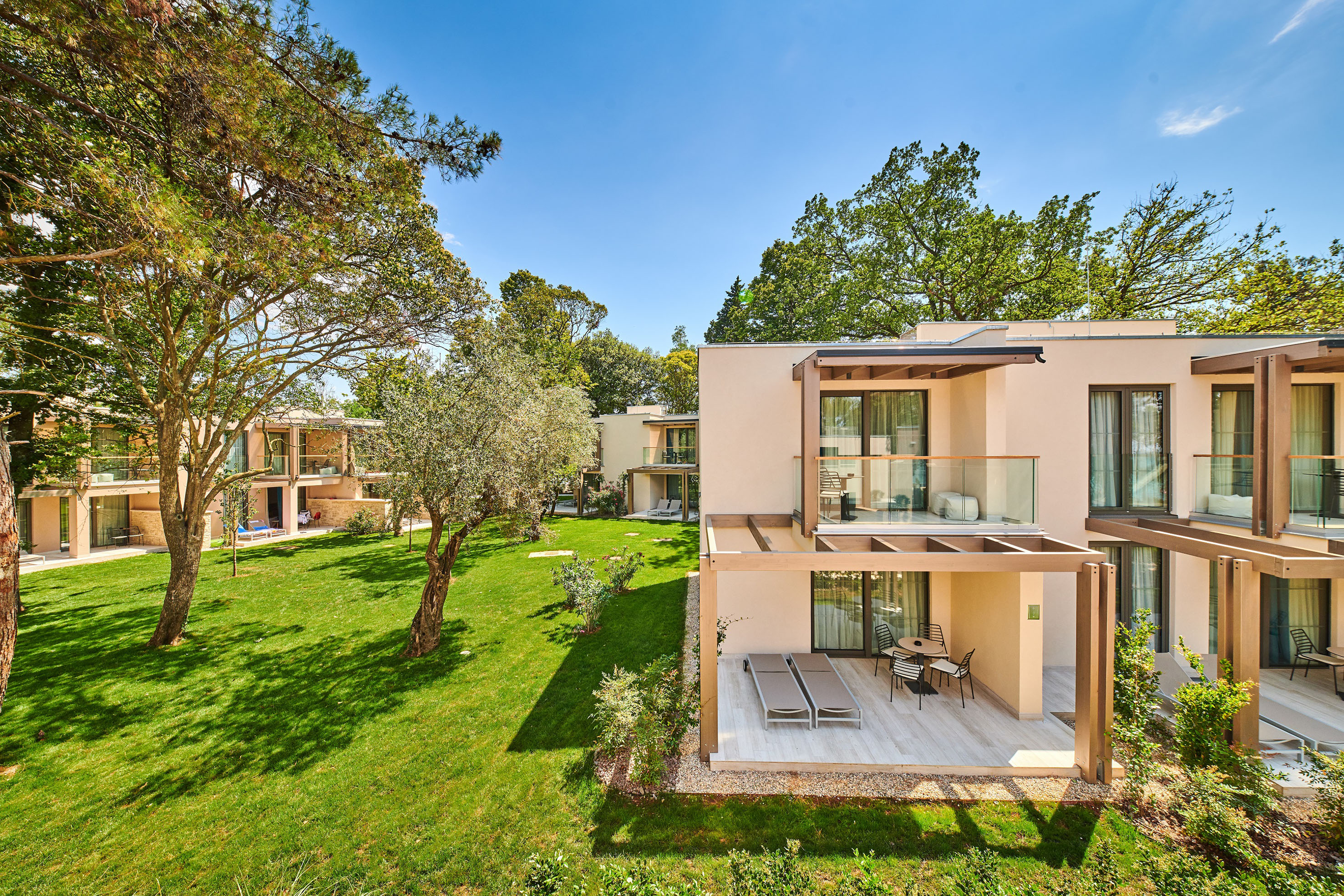 a building with a patio and grass in front of it