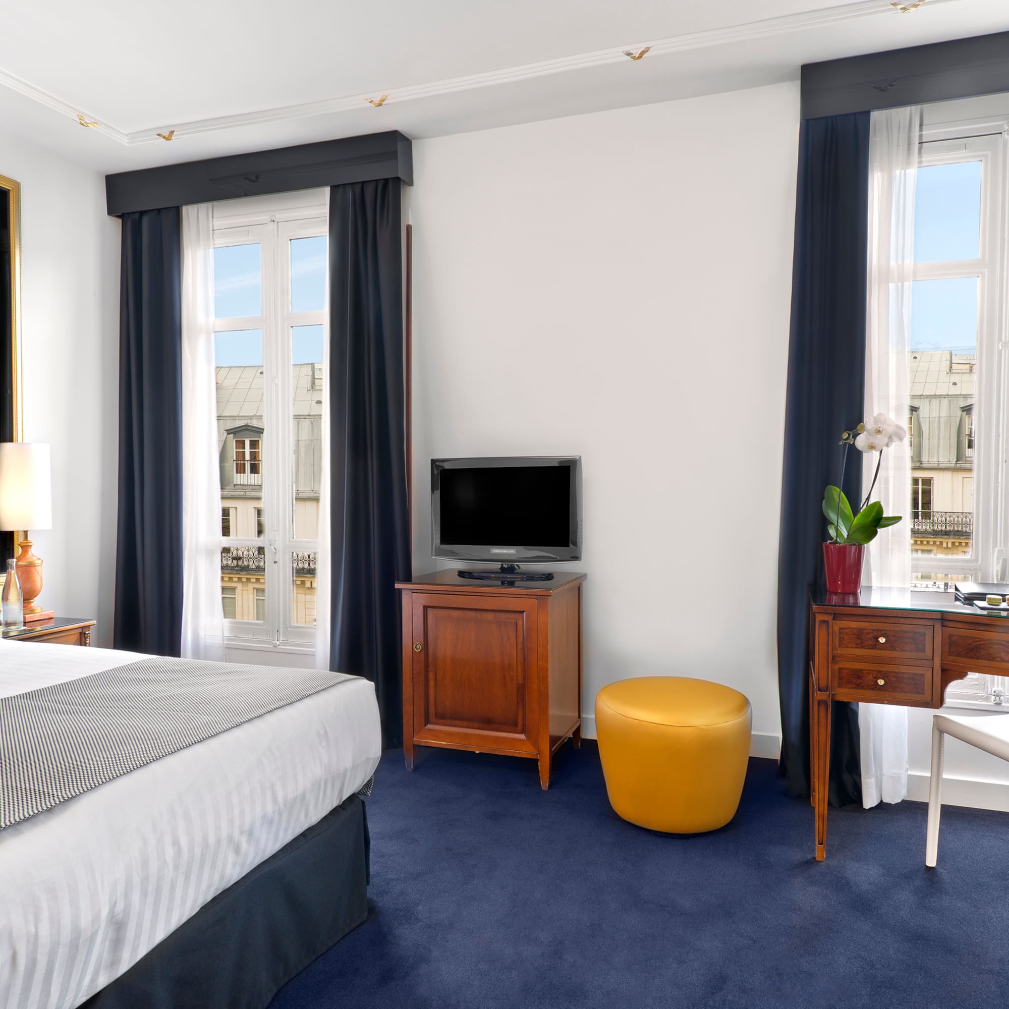 a bedroom with a tv and a table