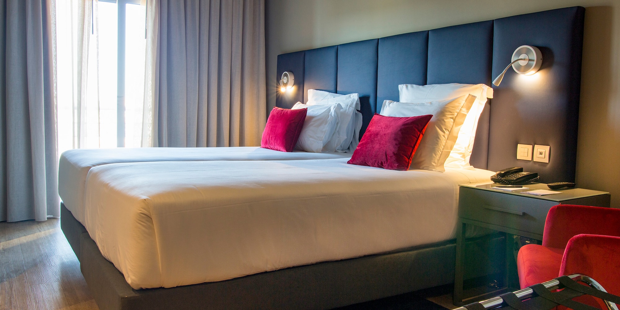 a bed with pillows and a lamp in a hotel room