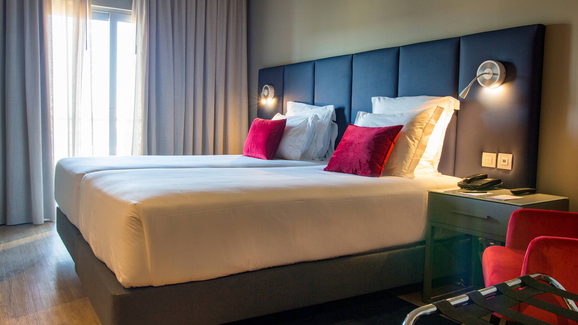 a bed with pillows and a lamp in a hotel room