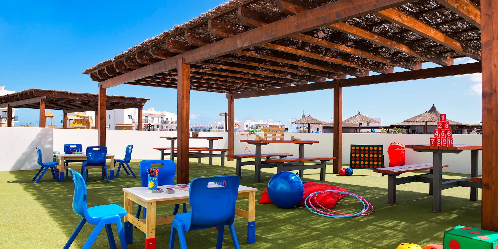 a covered area with tables and chairs