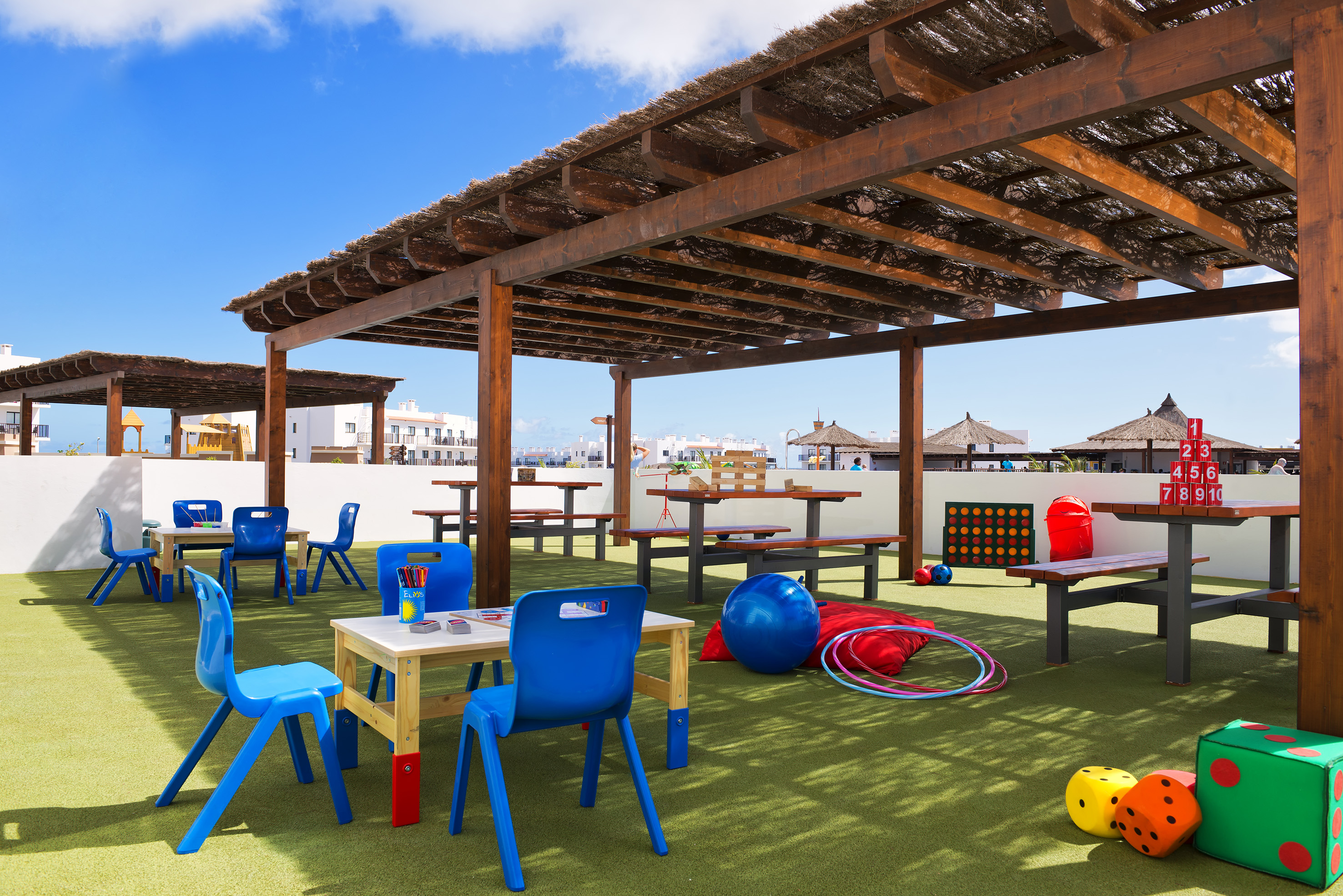 a covered area with tables and chairs