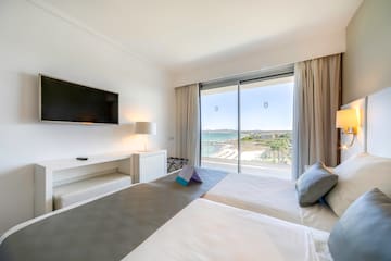 a room with a large window and a bed