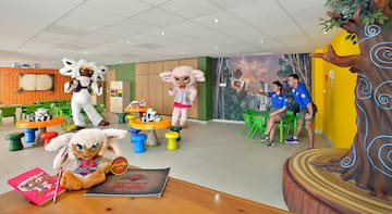 a group of people in a room with stuffed animals