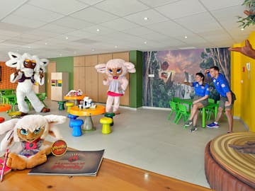 a group of people in a room with stuffed animals