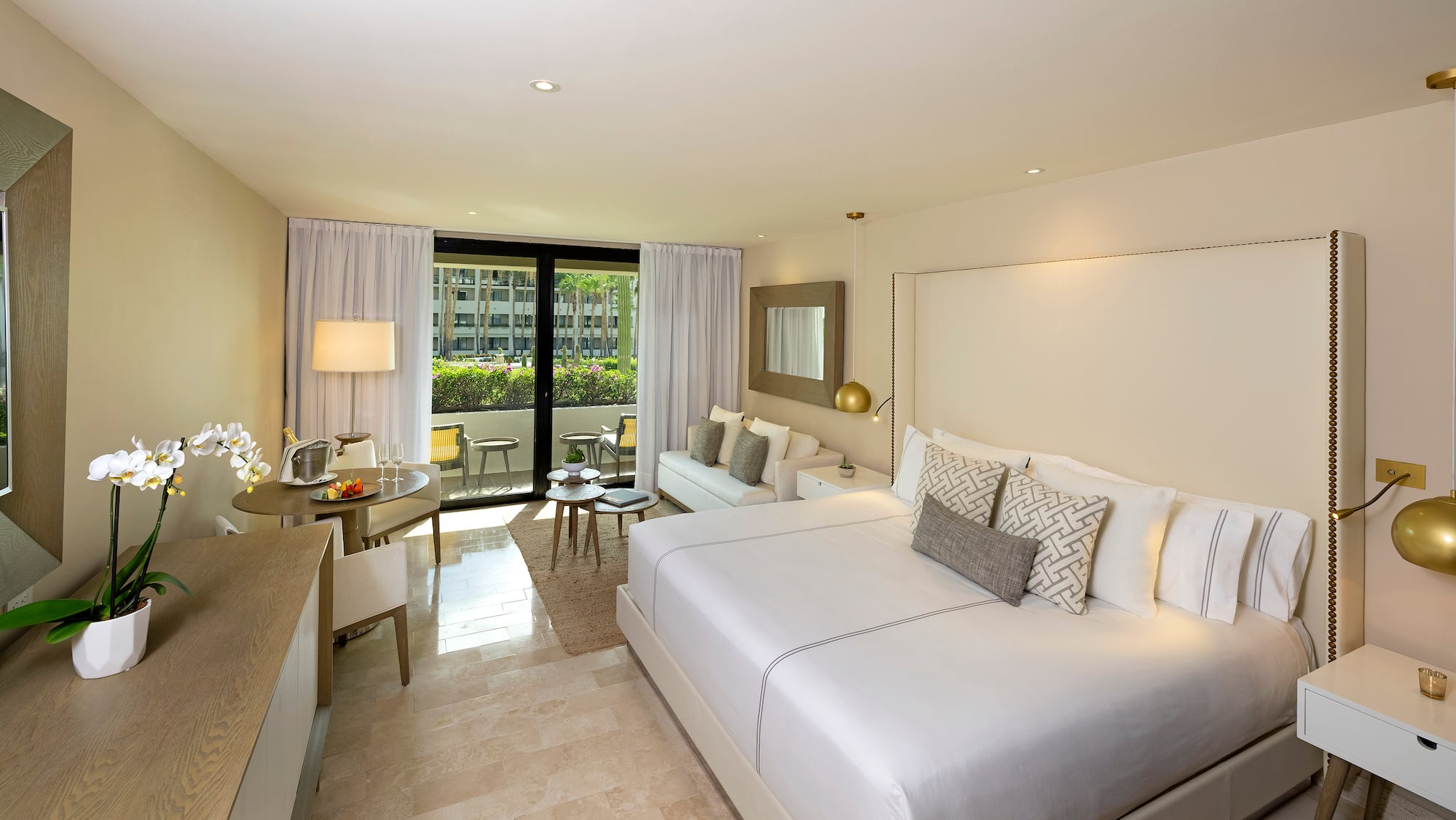 a room with a bed and a table and chairs