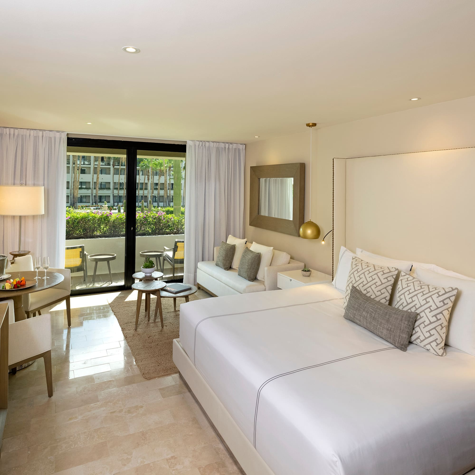 a room with a bed and a table and chairs