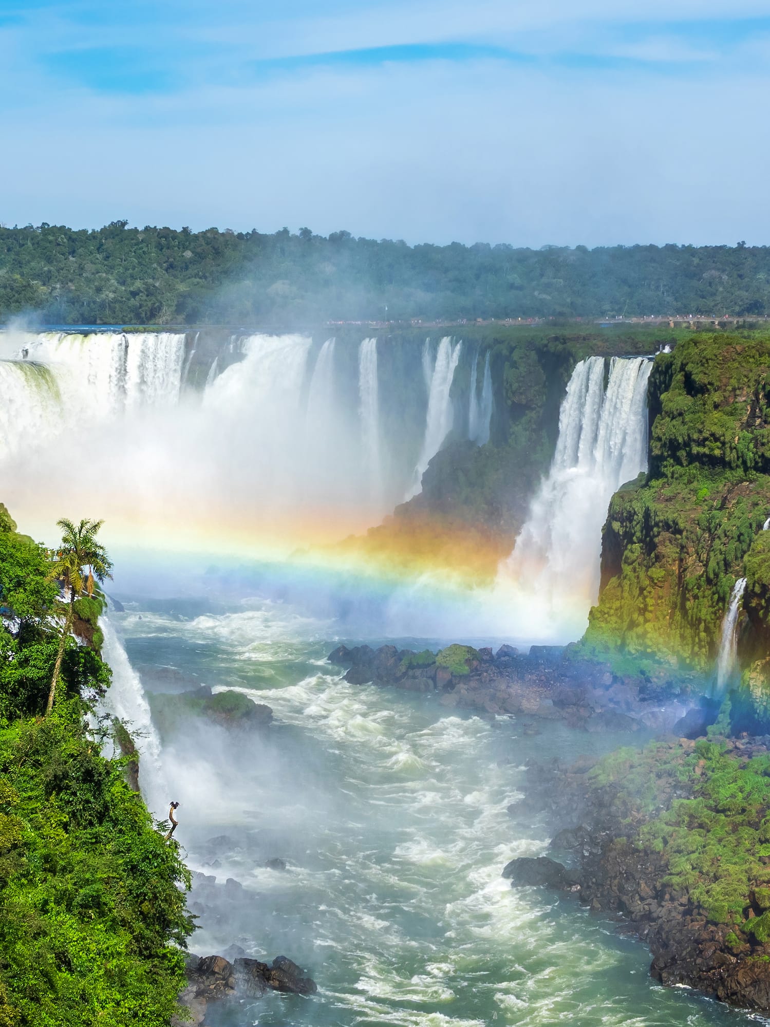 a rainbow over a waterfall