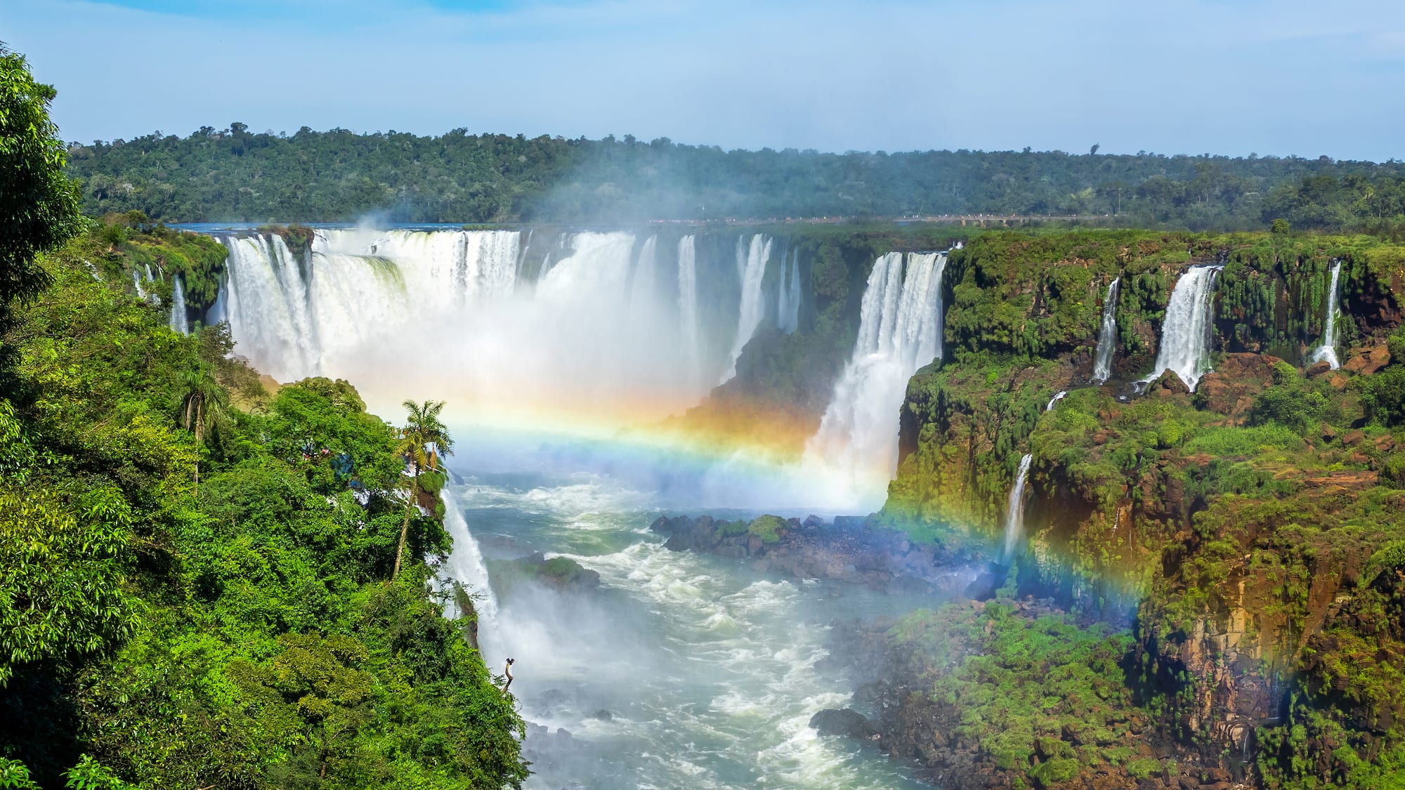 a rainbow over a waterfall