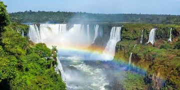 a rainbow over a waterfall