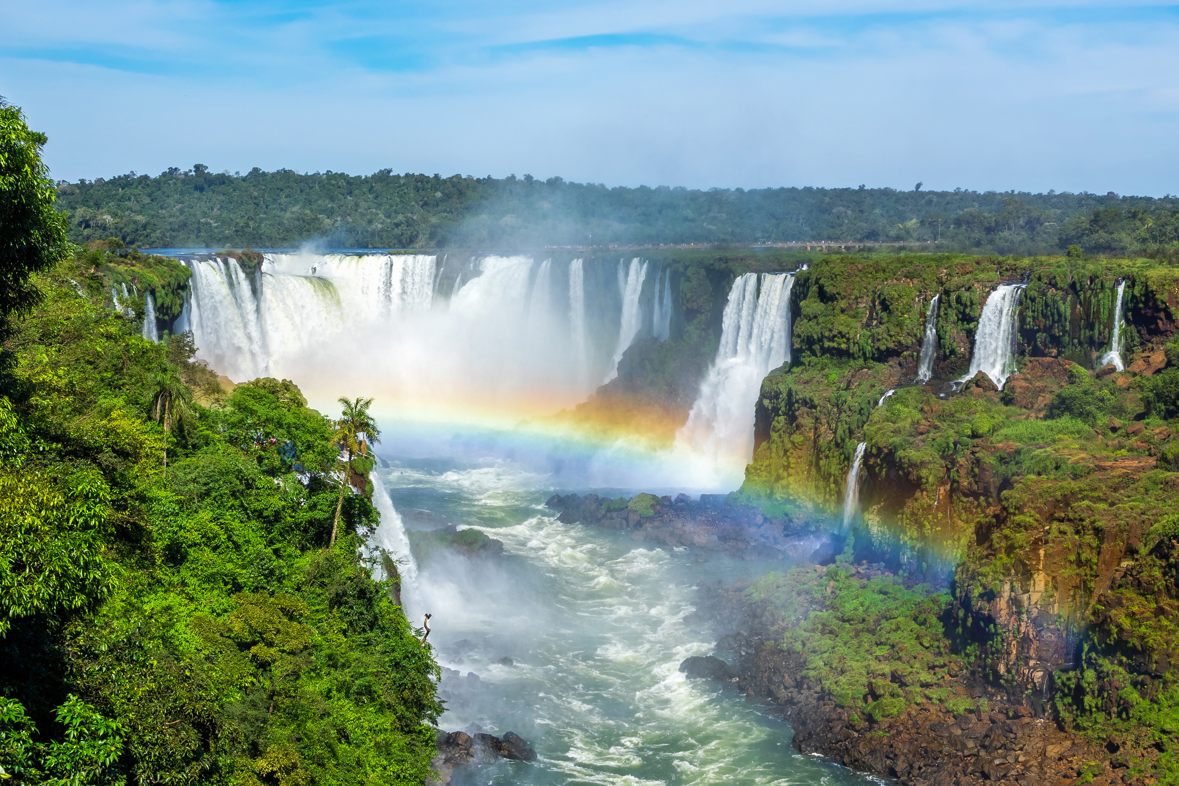 a rainbow over a waterfall