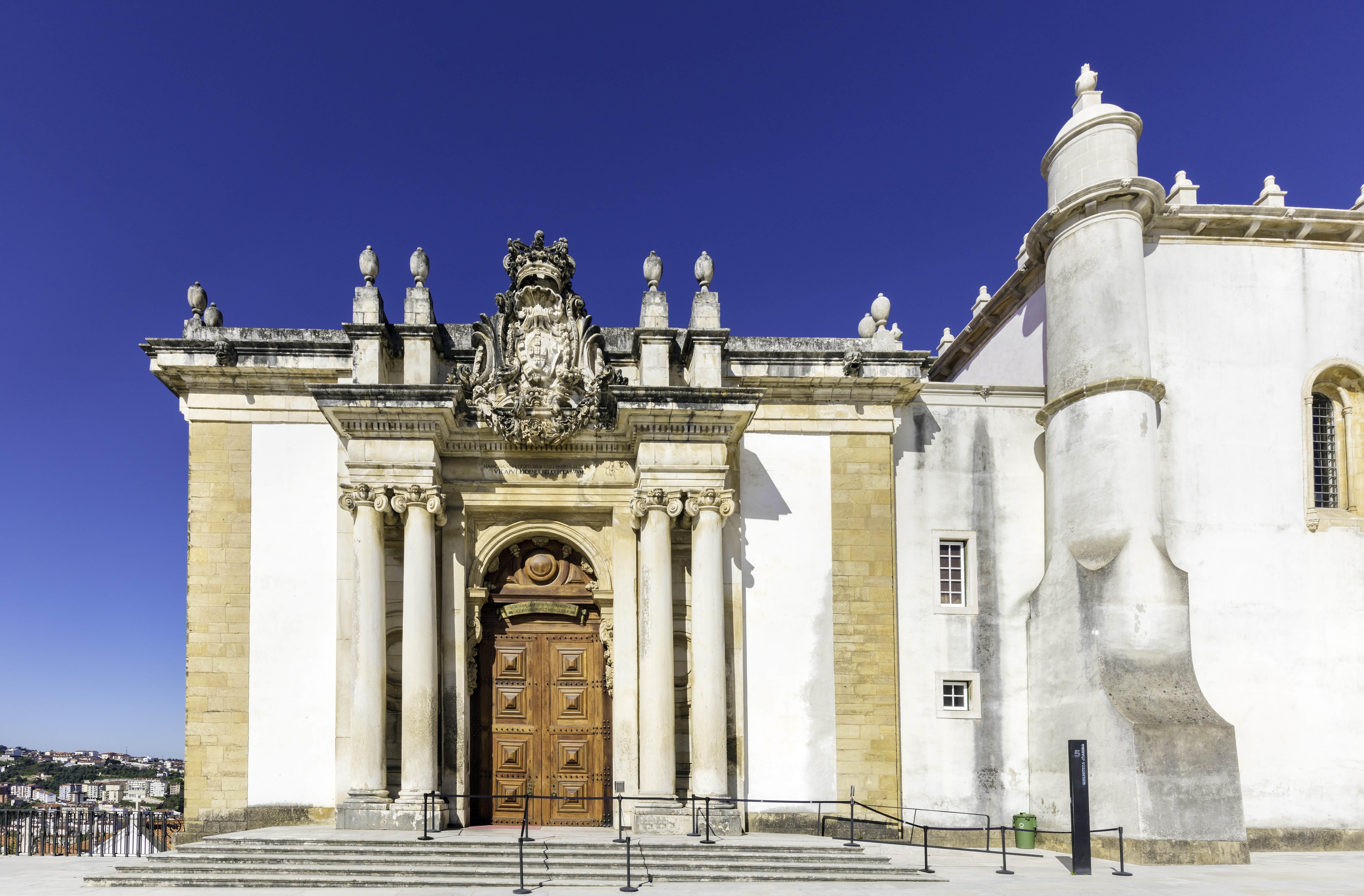 Coimbra University ornate Baroque facade with columns and elaborate crest.