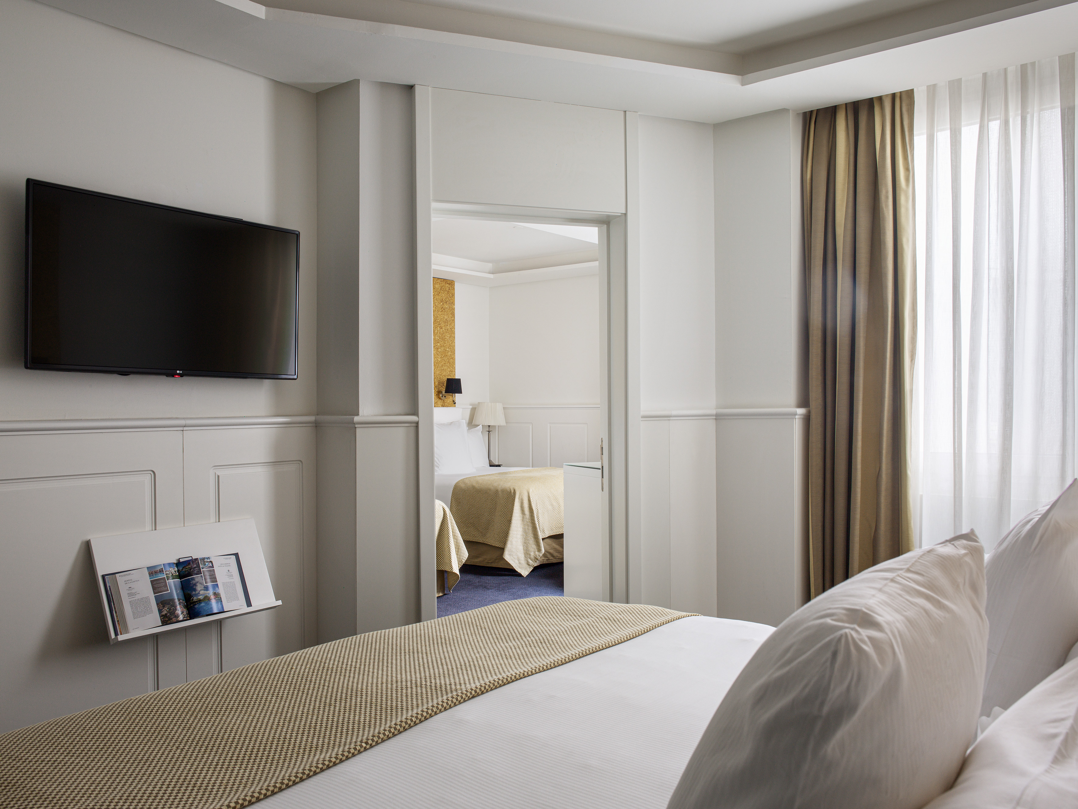 a room with a bed and a television