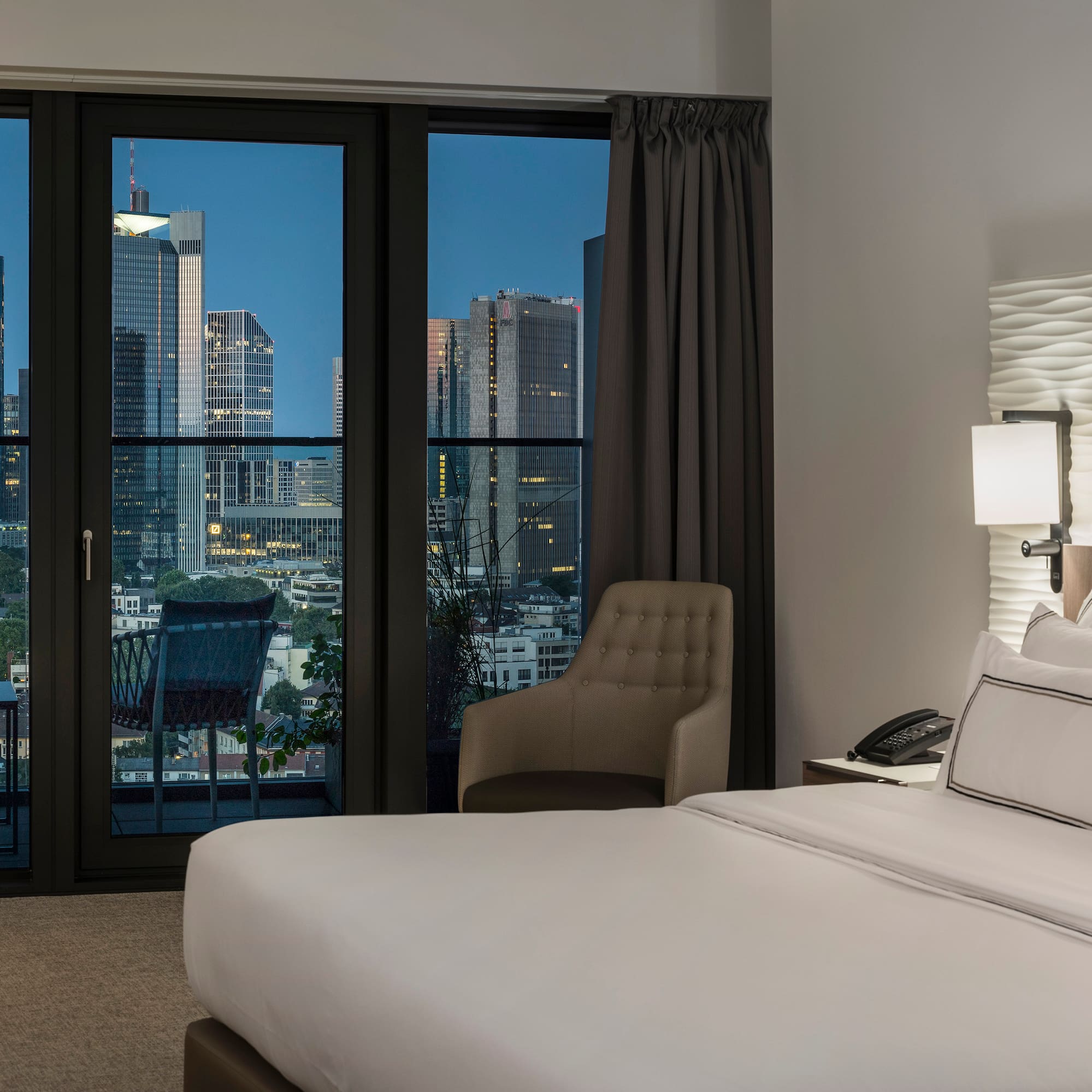 a bedroom with a large window and a bed